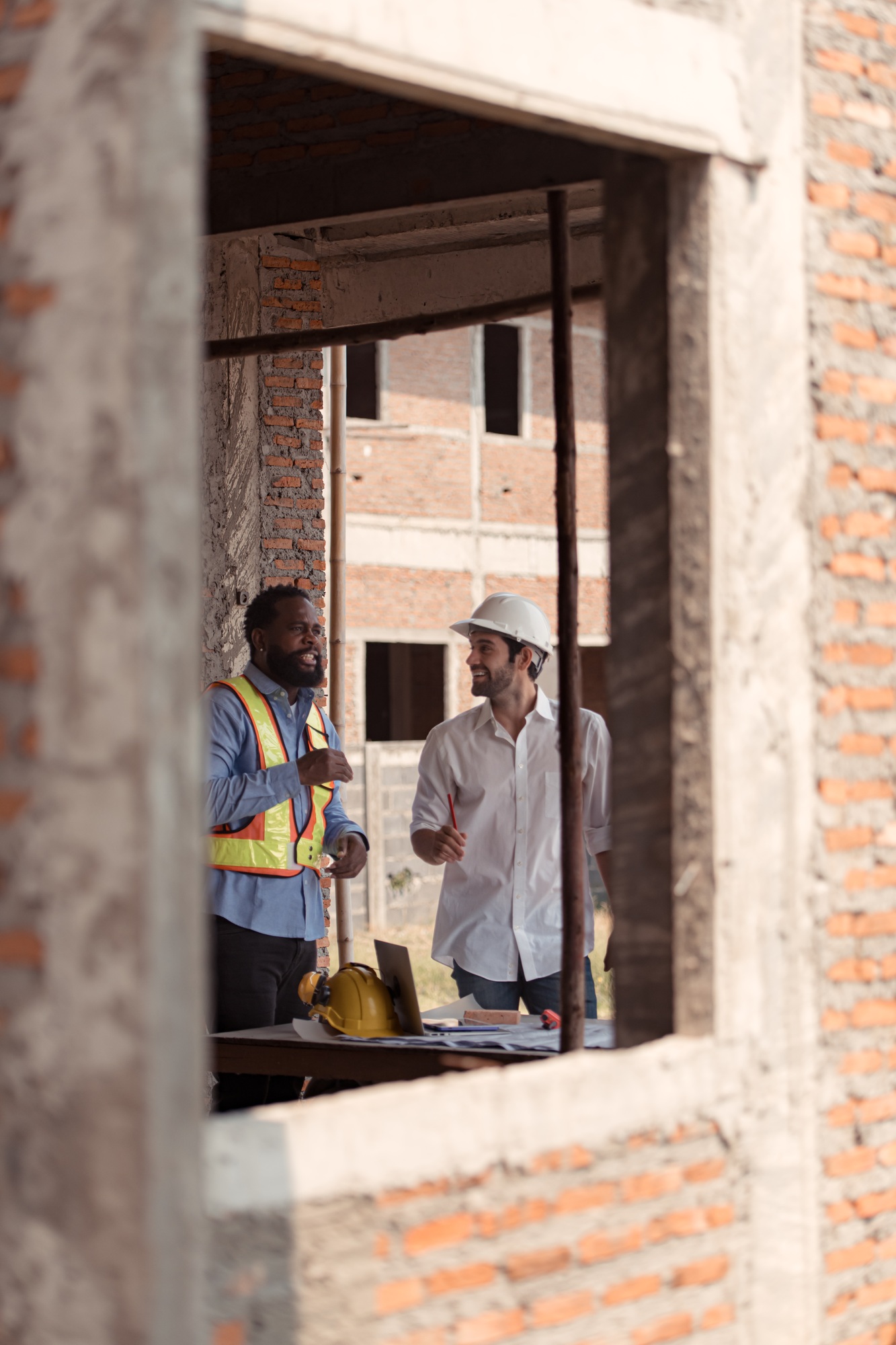 Architects and engineers work together to assess the residential home construction site's progress